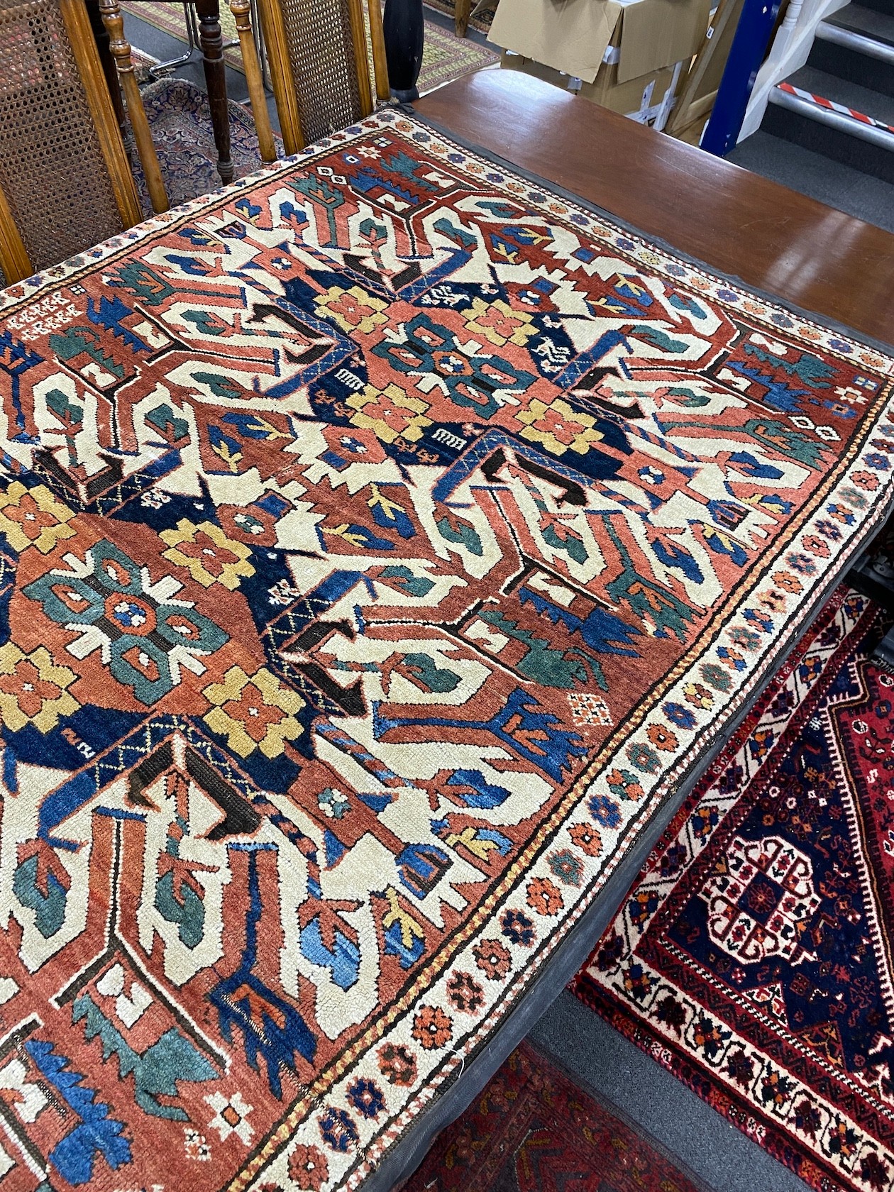 An antique Caucasian ivory ground Karabagh triple medallion rug, 224 x 130cm